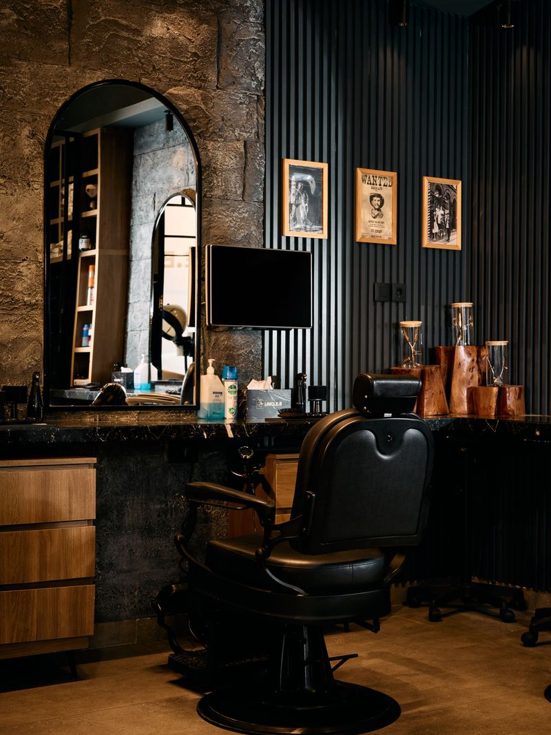 Barber chair, arched mirror and western frames inside Uncle B
